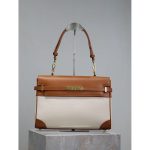 YSL Manhattan canvas underarm baguette in smooth box leather with protective studs