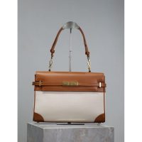 YSL Manhattan canvas underarm baguette in smooth box leather with protective studs