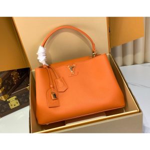 Louis Vuitton LV Capucines MM Top Handle handbag in orange calfskin